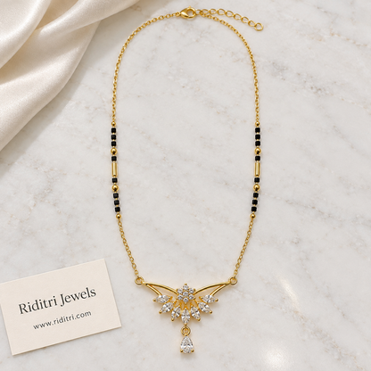Black bead mangalsutra chain with gold tube beads and winged stone pendant