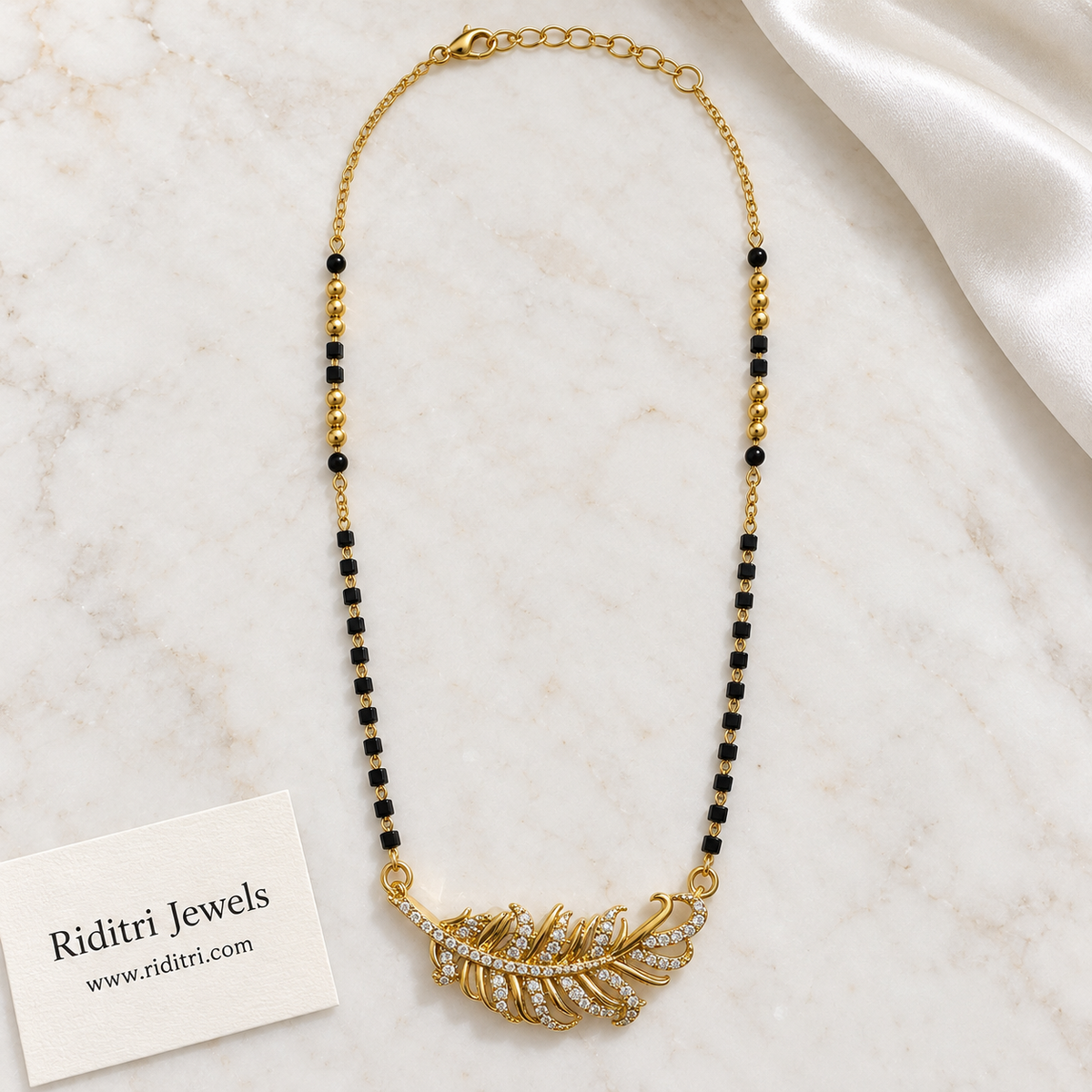 Black bead mangalsutra chain with polished gold beads and feather pendant