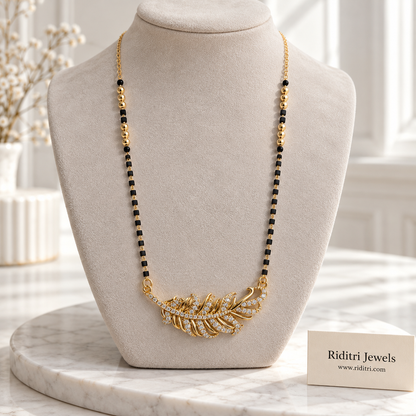 Gold-toned feather mangalsutra pendant with sparkling stones along the quill