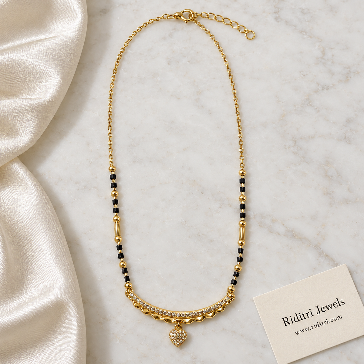 Gold-toned curved bar mangalsutra pendant with wavy edge and small heart drop