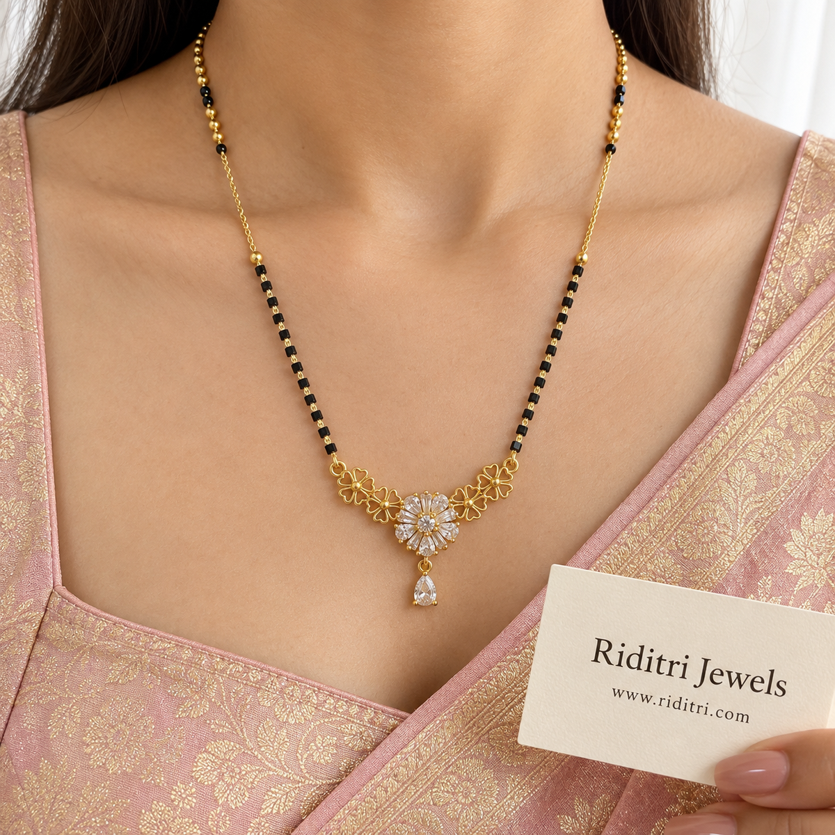 Gold-toned openwork flower mangalsutra pendant with pear and baguette stone bloom