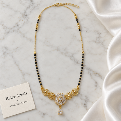 Long black bead mangalsutra chain with gold beads and floral teardrop pendant
