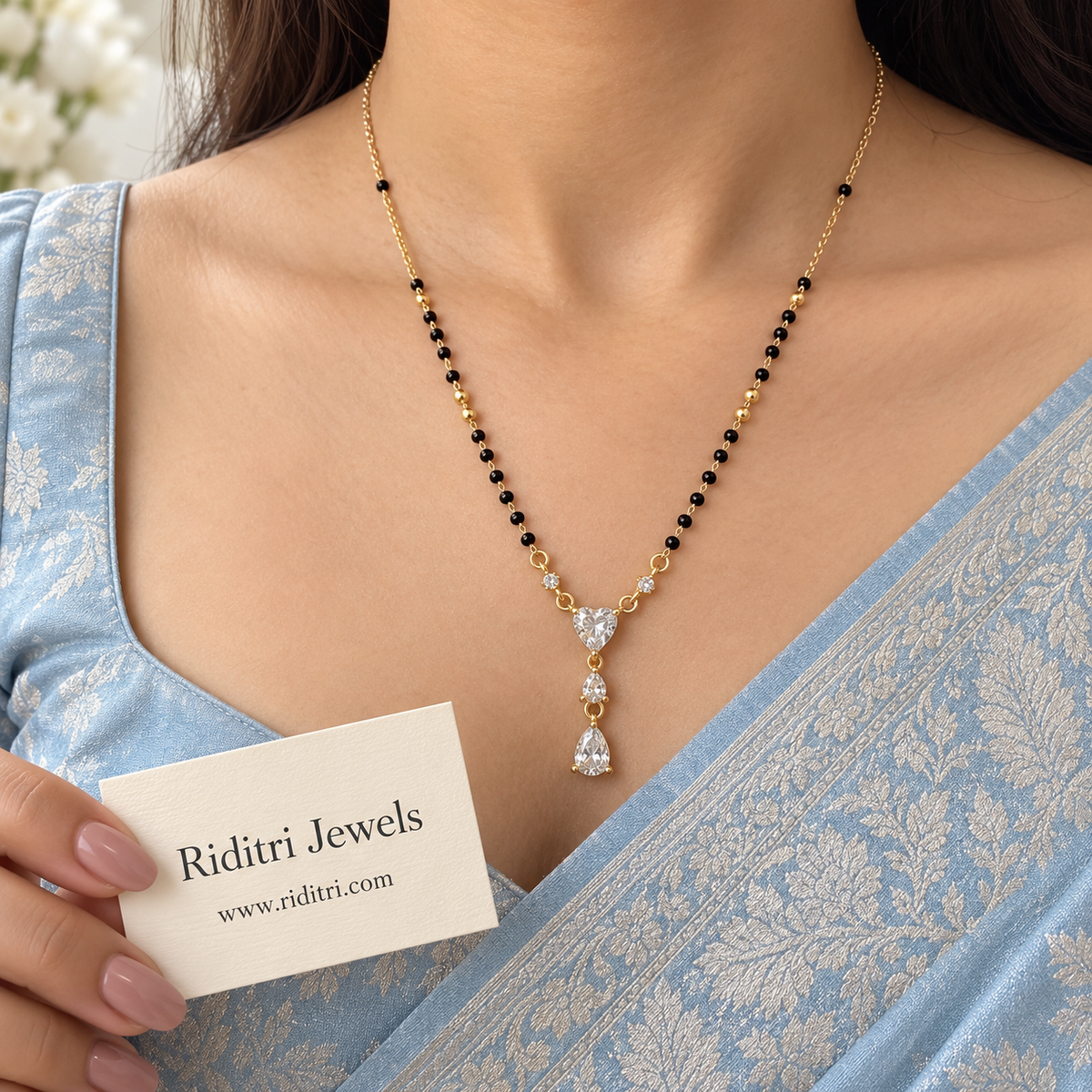 Gold-toned three-stone mangalsutra pendant with heart-cut and pear-cut stones