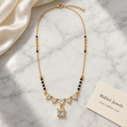 Black bead mangalsutra chain with gold beads and heart solitaire pendant