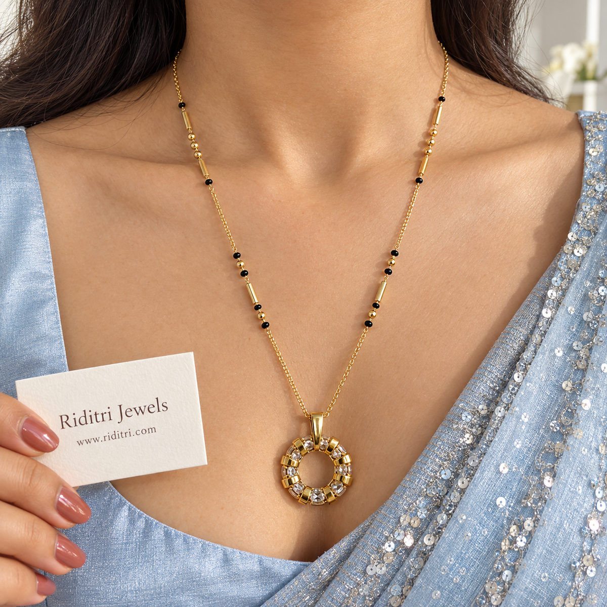 Gold-toned open circle mangalsutra pendant set with sparkling stones between gold bands