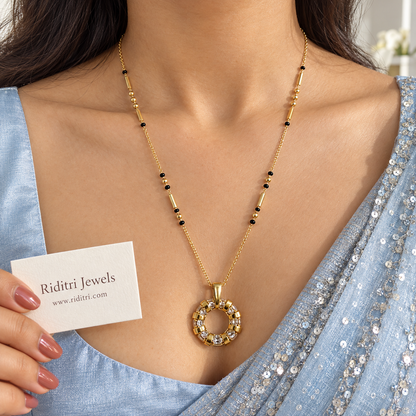 Gold-toned open circle mangalsutra pendant set with sparkling stones between gold bands