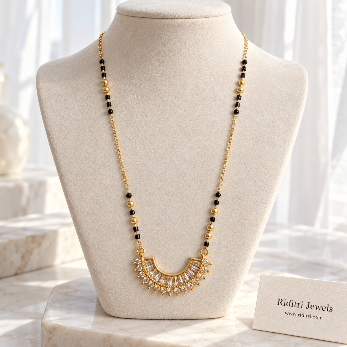 Gold-toned crescent mangalsutra pendant with fanned baguette stones and stone border