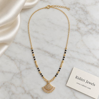 Black bead mangalsutra chain with gold ball and tube beads and shell pendant