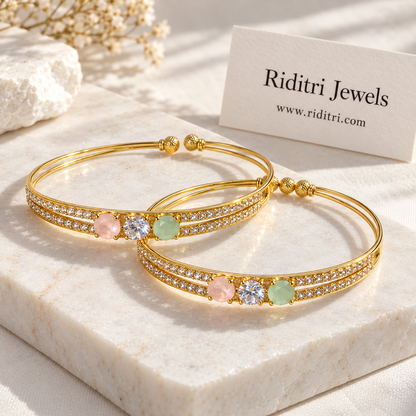 Gold-toned adjustable cuff bangle with three prong-set stones and rows of AD stones