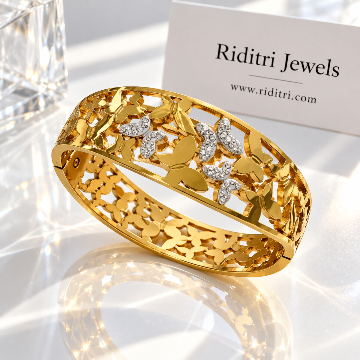 Detail of Aura Flutter gold-toned butterflies set with sparkling CZ stones